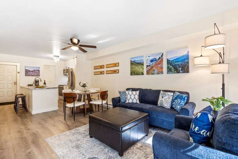 Gather in the open-concept living space featuring dining for four and seamless access to your private deck — perfect for relaxing or entertaining.