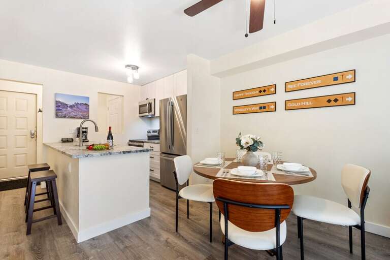 Open concept living-dining-living area- features dining for 4 as well as bar seating for two.