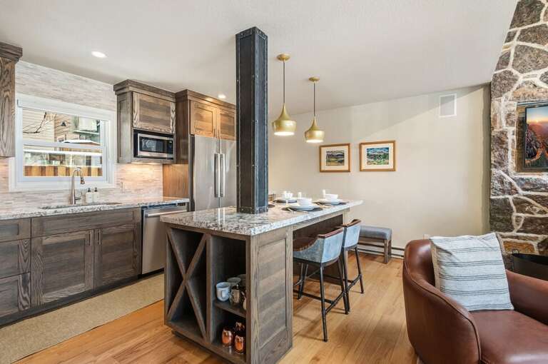 A bright open kitchen with a gas stove, double-door fridge, dishwasher, and microwave, offering ample counter space and modern style — perfect for the chef in you.