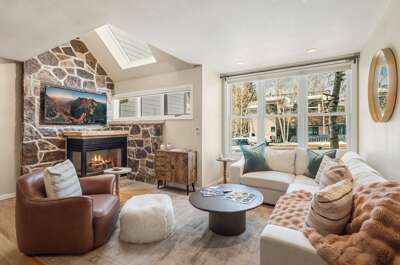 Cozy two bedroom two bathroom multi-level condo with gas fireplace, modern kitchen and open concept living area.