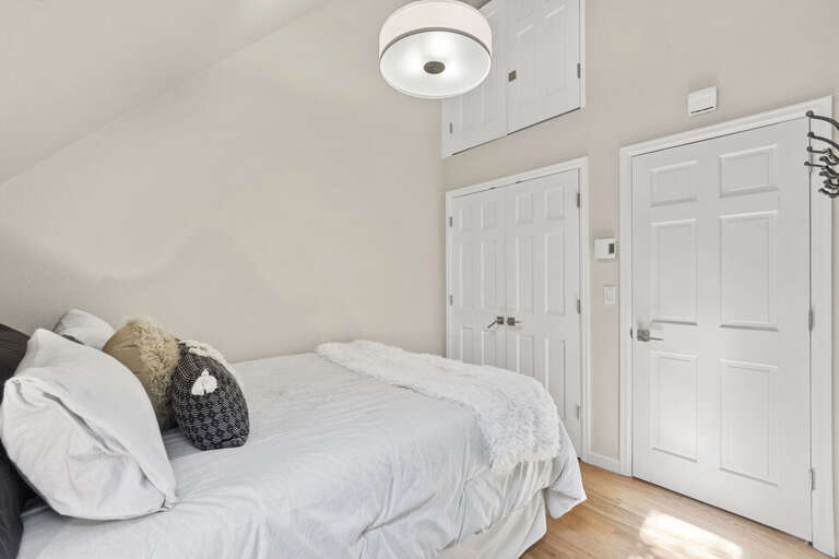 A cozy guest room featuring a comfortable sitting area, and skylights that fill the space with natural light.