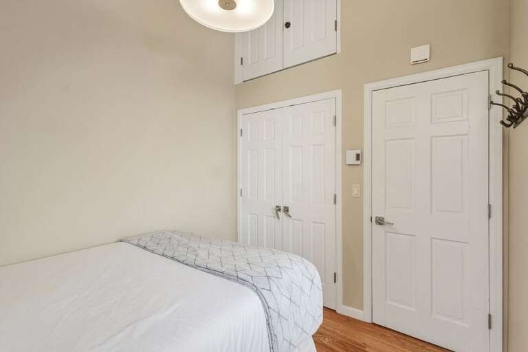 A cozy guest room featuring a comfortable sitting area, and skylights that fill the space with natural light.