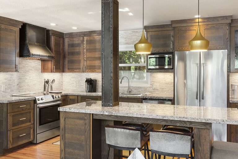 A spacious open kitchen featuring modern appliances, abundant natural light, and plenty of counter space.