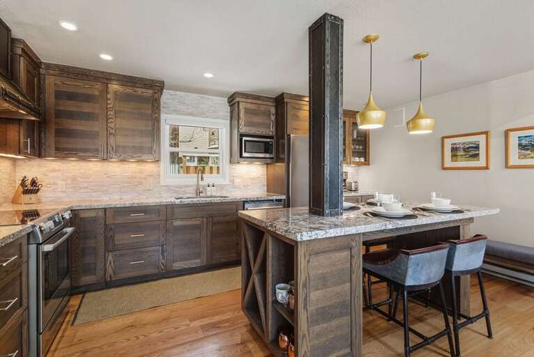 A spacious open kitchen featuring modern appliances, abundant natural light, and plenty of counter space.