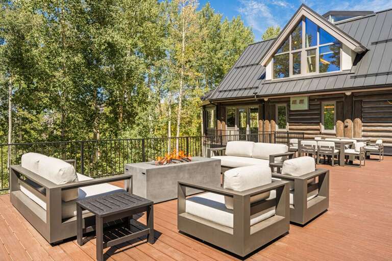 Comfortable outdoor seating area with fire pit overlooking the Aspen Forest.