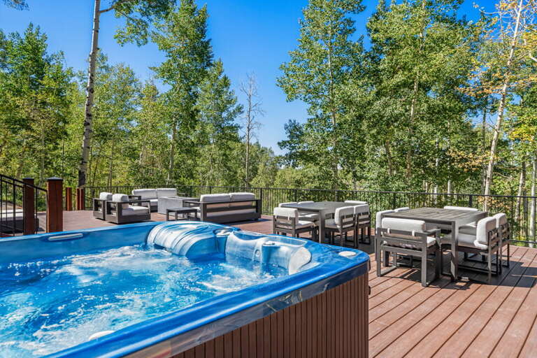 Relax in the hot tub with mountain views and spacious deck area.