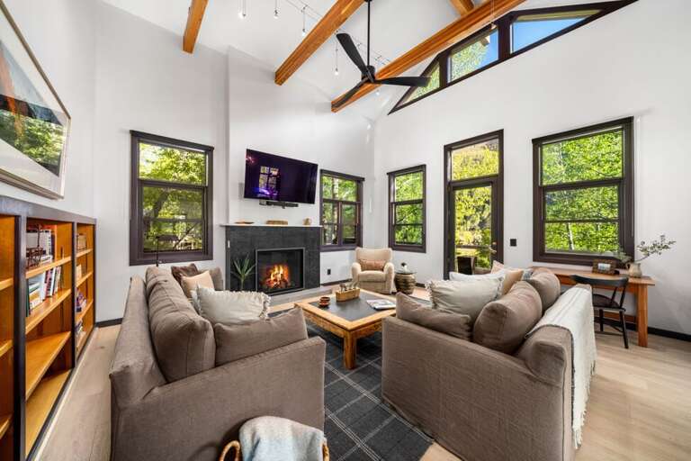 Cozy living area with gas fireplace with easy access to the stunning outdoor porch and hot tub.
