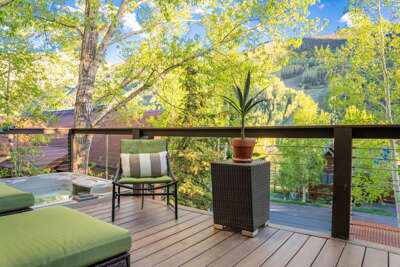 Stunning Deck with hot tub and outdoor lounging area, gas grill and mountain views.