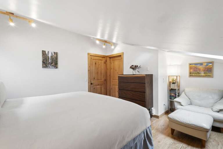 Amazing light filed primary with kind bed, ensuite and reading area.