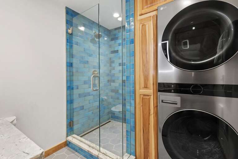 Second bathroom features walk in shower, washer and dryer and single vanity.