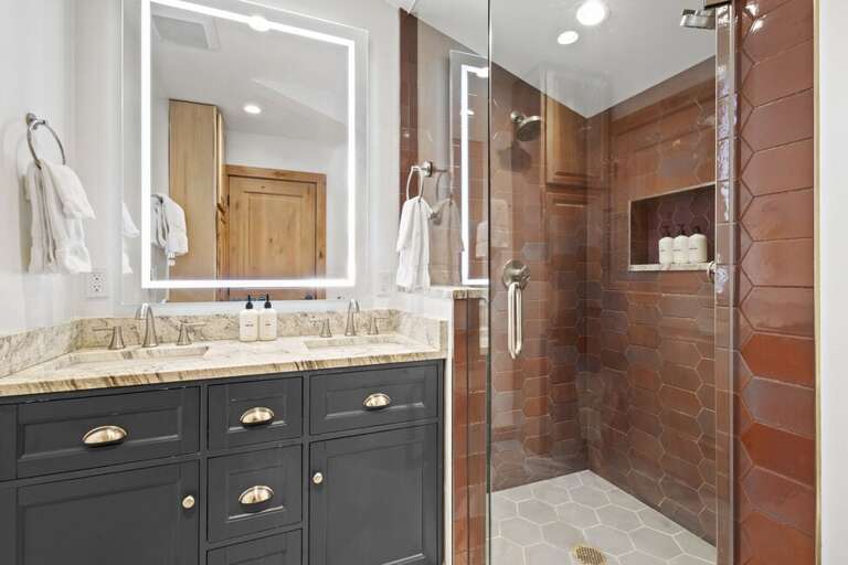 Beautiful tiled step in shower and double sink vanity is features in the primary suite.