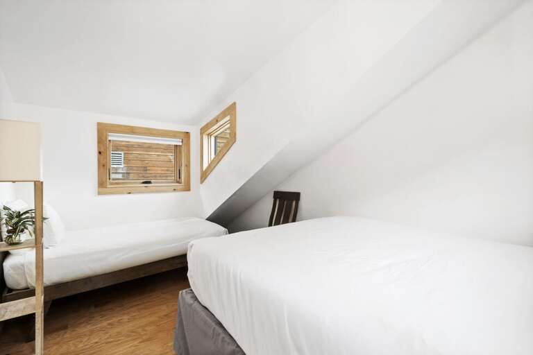 Cozy guest room with queen bed and single bed.