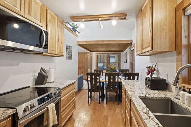 Galley kitchen stocked with all your cooking needs.