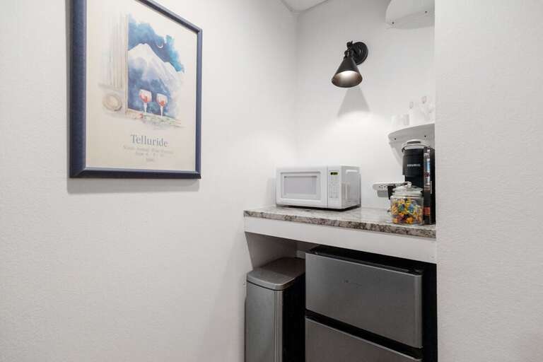 Simple snack station with mini fridge/freezer, microwave and Keurig coffee maker.