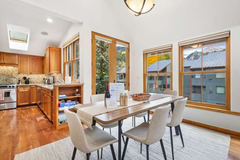 Spacious dining area with seating for six and beautiful mountain views.