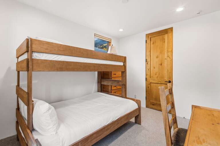 Comfortable bunk room with a full-size lower bunk and twin upper bunk.