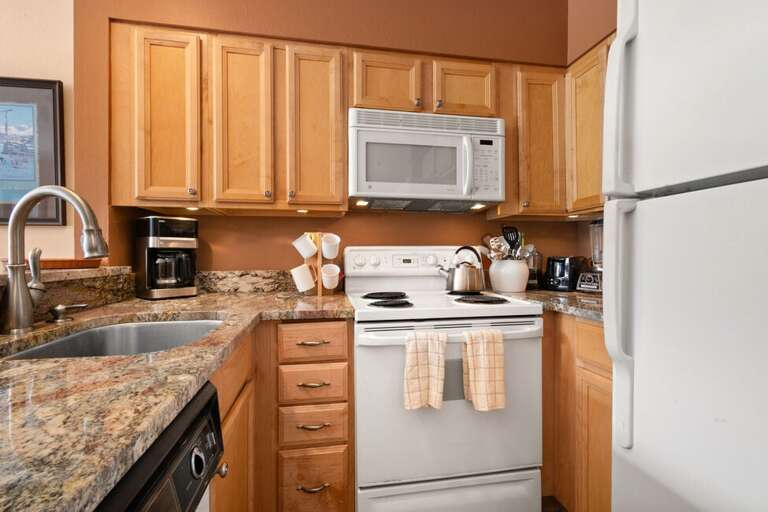Coffee maker, stove, full size refrigerator.