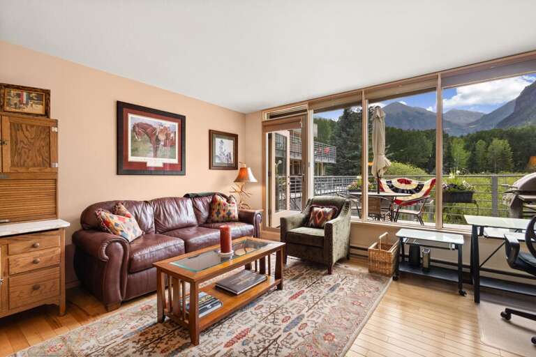 Comfortable living room with access to deck with Ajax Peak views.