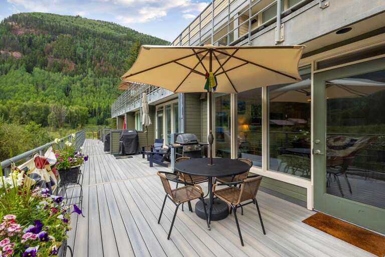 Wonderful deck area with gas grill and dining table.