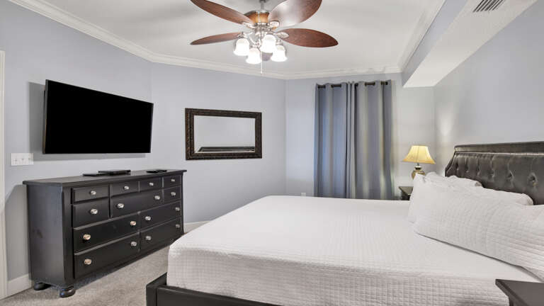 Bedroom Interior With Large Bed, Dresser, And Television Bedroom Interior With Large Bed, Dresser, And Television