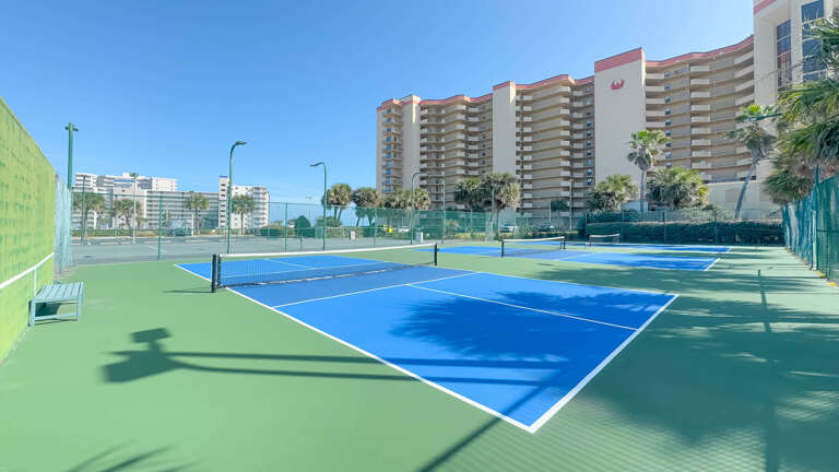 Tennis Courts With Tall Buildings In The Background