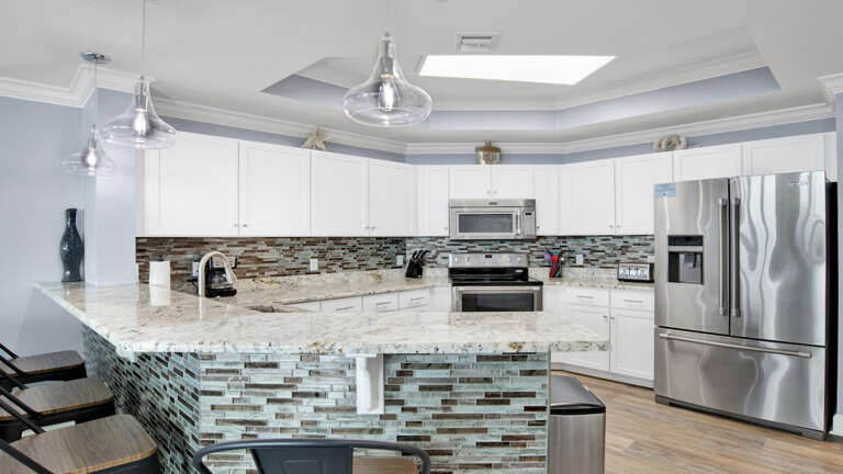 Residential Kitchen Interior With Island And Stainless Steel Appliances