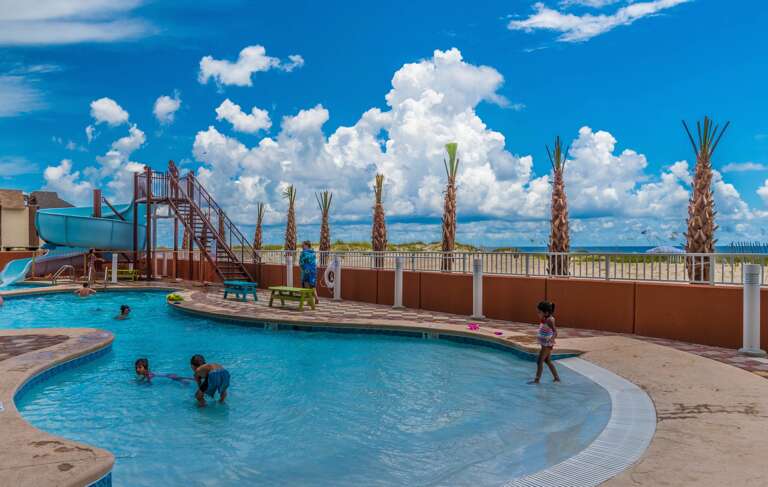 Phoenix Gulf Shores Exterior Zero Entry Pool with Corkscrew Waterslide