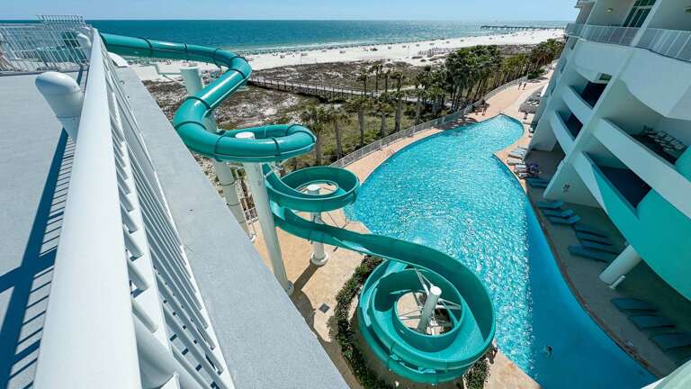 High-rise Building With Water Slides And Pool Overlooking The Beach