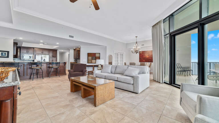 Interior View Of A Spacious Living Room Leading To A Balcony With Ocean View In A Vacation Rental Interior View Of A Spacious Living Room Leading To A Balcony With Ocean View In A Vacation Rental