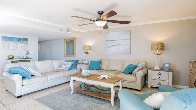 Bright Living Room With Sofas, Coffee Table, And Ceiling Fan