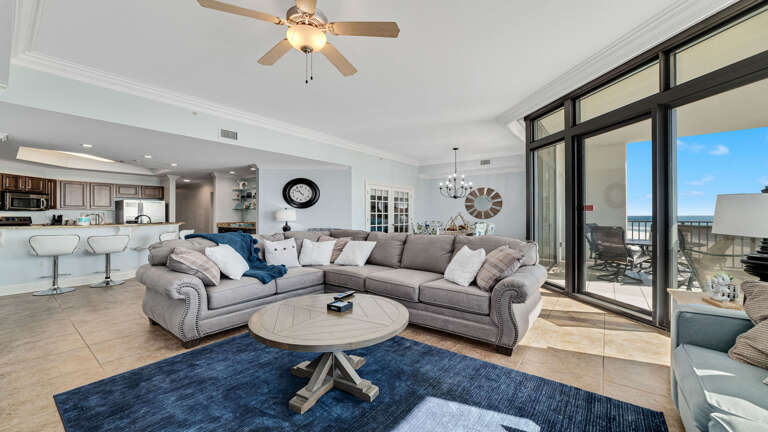 Interior Living Space With Sectional Sofa, Kitchen, And Balcony Access Interior Living Space With Sectional Sofa, Kitchen, And Balcony Access