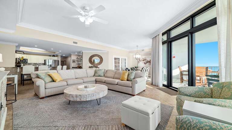 Spacious Seaside Living Area With Plush Seating And Panoramic Patio View, Perfect For A Serene Stay