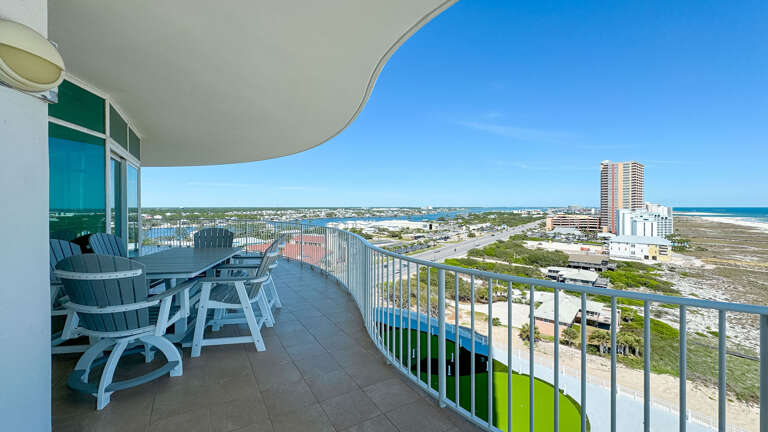 Balcony View Of Coastline With Outdoor Furniture