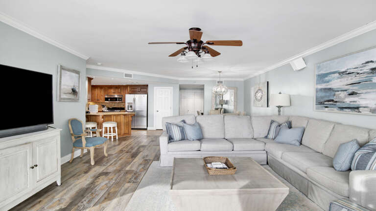 Interior Living Space With Sectional Sofa And Adjacent Kitchen