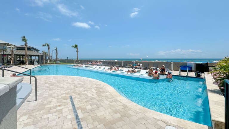 Swimming Pool With Guests By The Sea