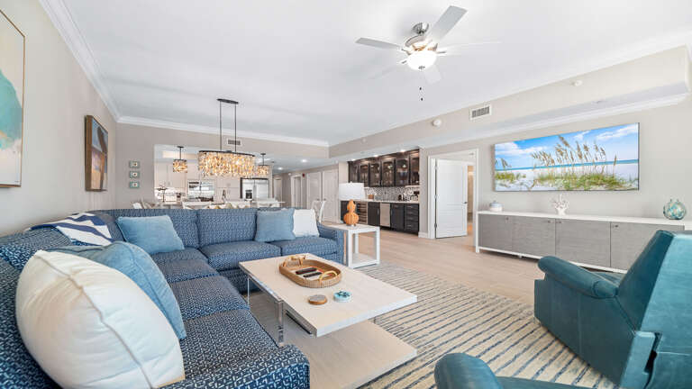 Living Area With Sectional Sofa, Coffee Table, And Open Kitchen Living Area With Sectional Sofa, Coffee Table, And Open Kitchen