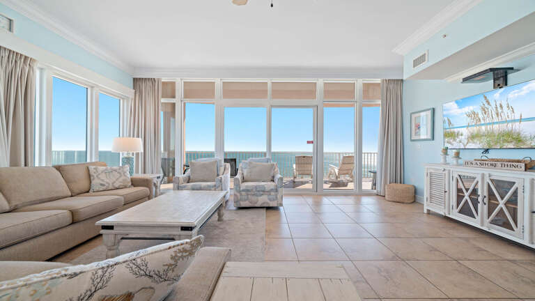 Spacious Living Room With Sea View, Large Sofas, And Glass Doors