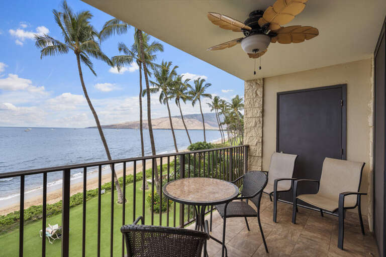 Balcony By Beach With Breezy Palms And Table Chairs Facing Water