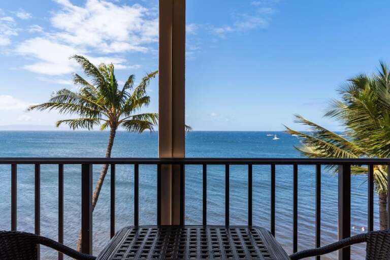 Balcony View With Palm Trees, Sea, And Sailboats