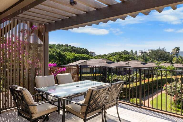 Patio Furniture Facing Vibrant Vegetation Under Vibrant Veranda