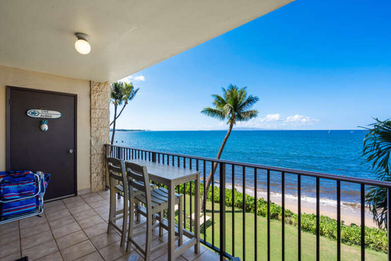 Balcony View Of Blue Beach, Breezy Palms, And Bright Horizon