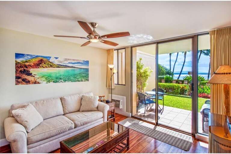 Bright Beachside Living Room Leading To Lush Lawn
