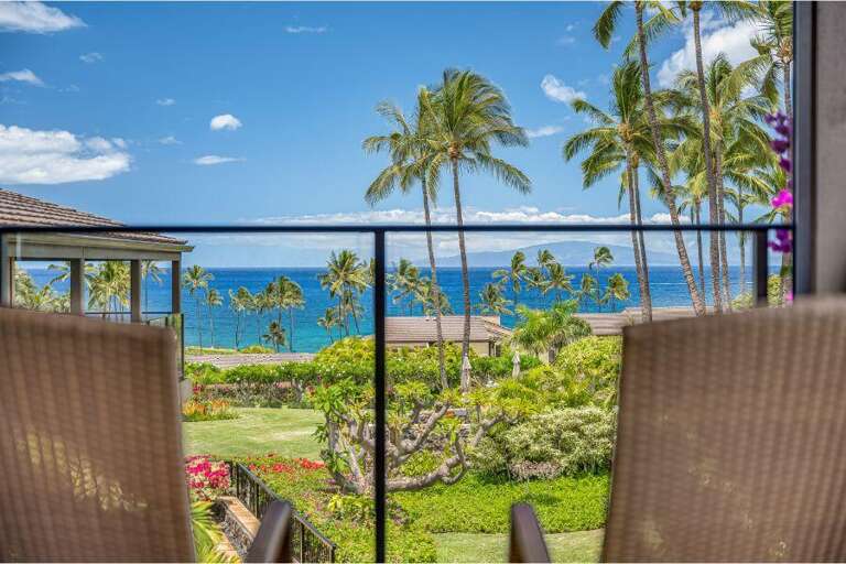 Balcony View Of Blue Sea, Green Garden, And Tall Palms