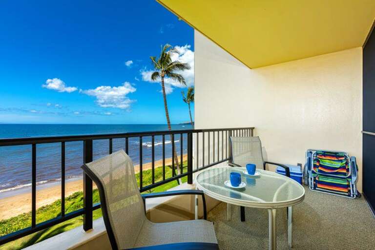 Balcony View Of Beach, Blue Ocean, And Palm Trees From Vacation Rental