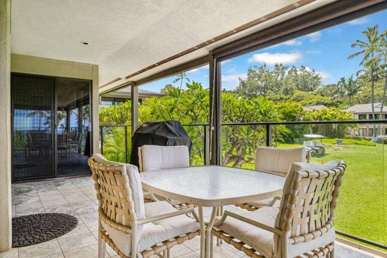 Patio Space With Chairs, Table, And Green Garden View Through Glass