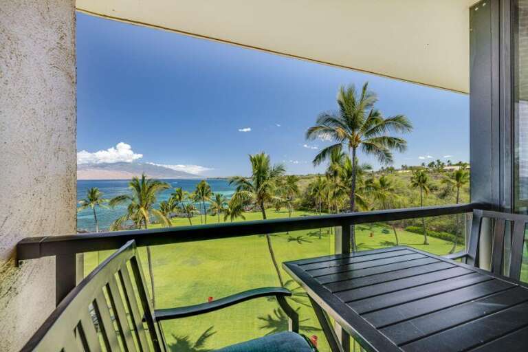 Balcony View Of Beach, Palms, And Distant Mountains