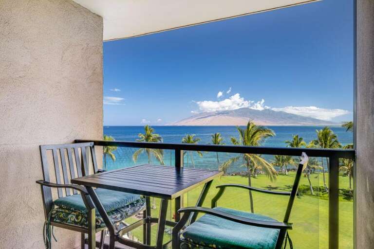 Balcony View Of Beach, Blue Skies, And Distant Mountain From Vacation Rental