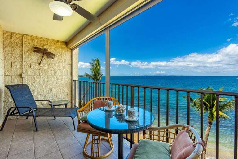 Balcony View With Blue Ocean, Breezy Palms, And Bright Sky
