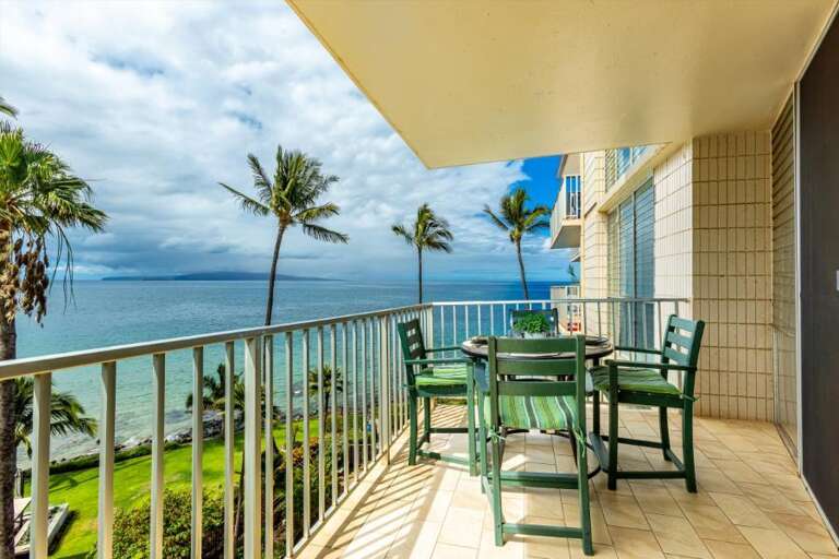 Balcony View With Beach Backdrop, Palms And Patio Chairs