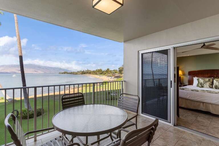 Balcony View Of A Serene Sea Scene From A Vacation Rental